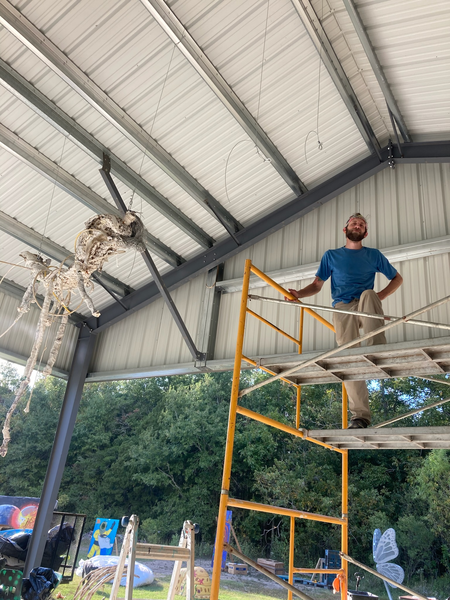 Our fearless author, atop a scaffold, wearing a cocky grin deserving of a fall
